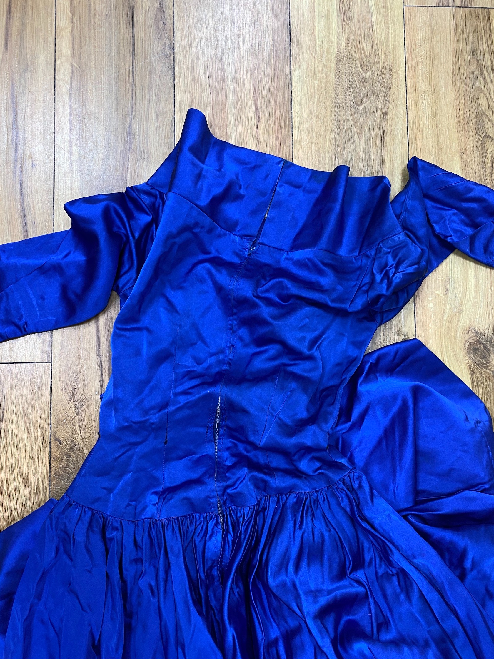 A blue 1950s ballgown, together with a Jean Varon black velvet button up dress